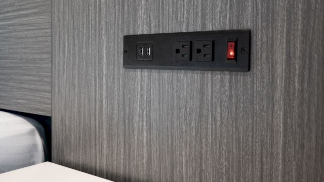 A close-up of a wall outlet with USB ports.