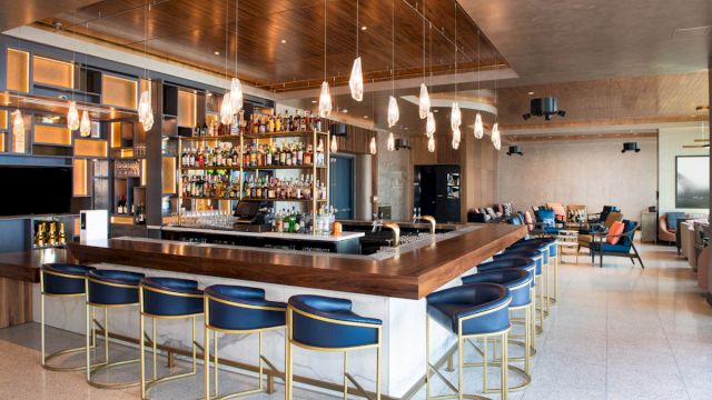 a bar with blue stools and a wooden counter
